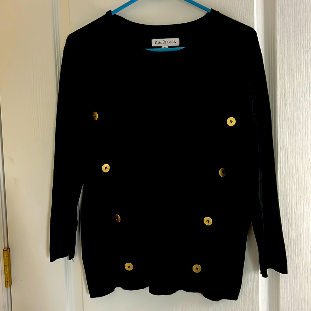 Black sweater with gold button design.